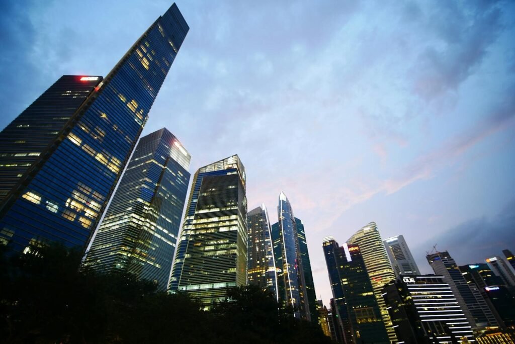 Low angle view of illuminated skyscrapers against a twilight sky, capturing urban architecture and city life.