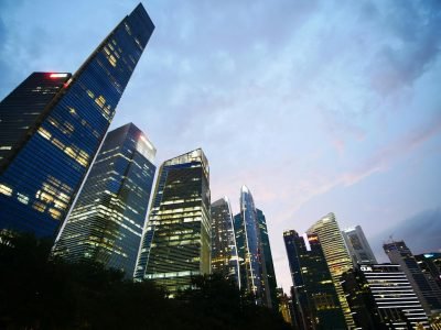 Low angle view of illuminated skyscrapers against a twilight sky, capturing urban architecture and city life.