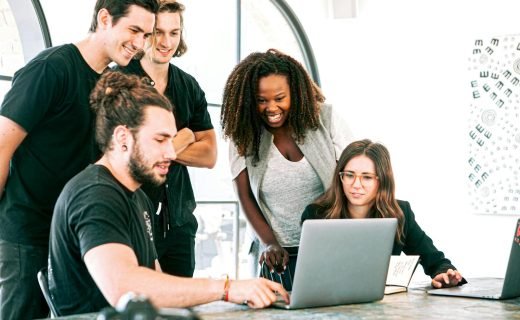 Dynamic team of young adults collaborating on project in bright modern office environment.