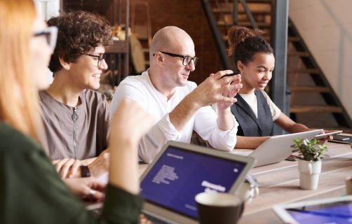A diverse group of professionals engaging in a collaborative brainstorming meeting.