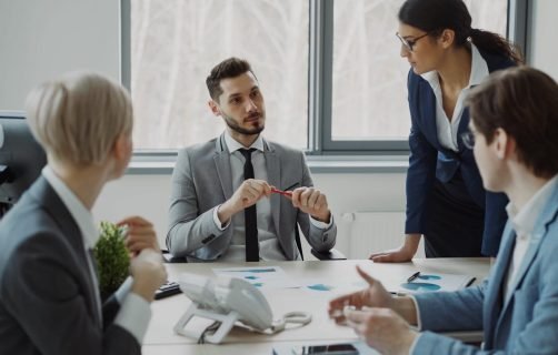 Professional team discussing business strategy in a modern office setting.