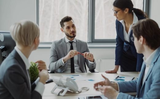 Professional team discussing business strategy in a modern office setting.