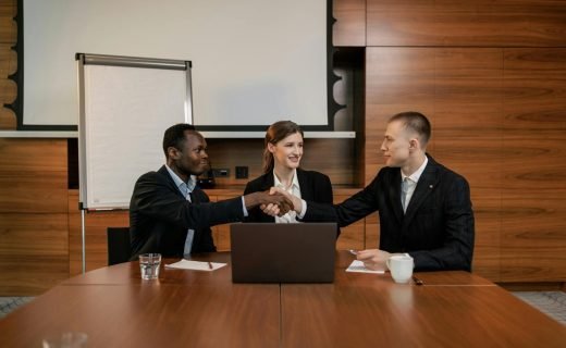 Diverse business team having a successful meeting and agreement, shaking hands across the table.