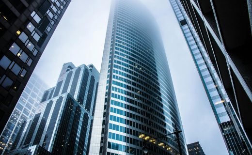Dramatic view of modern skyscrapers shrouded in fog in an urban cityscape.