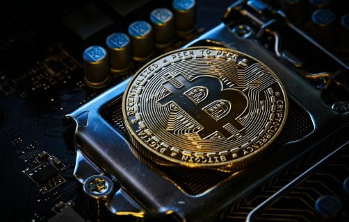 a bitcoin on top of a computer motherboard