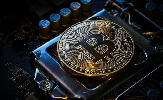 a bitcoin on top of a computer motherboard