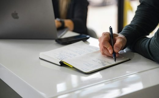 person writing on white paper